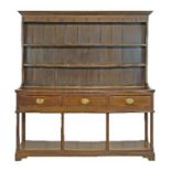 George III oak dresser, the plate rack fitted two shelves, the base fitted three drawers to the