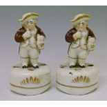 Pair of 19th Century Staffordshire figural pen holders, each formed as a toper, 11.5cm high