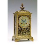 19th Century brass and black enamel cased mantel clock, the top having a foliate finial, blue enamel