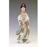 Japanese porcelain figure of a lady, her robe decorated with foliate sprays, 30.5cm high