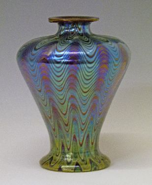 Iridescent glass baluster shaped vase having blue, green and yellow wavy decoration, 19.5cm high