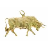 Large charm or pendant in the form of a charging bull, modelled in the round, unmarked, 4.5cm