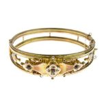 Edwardian 9ct gold hinged bangle, Birmingham 1907, the frontispiece set with red pastes and rose