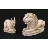 19th Century carved ivory figure of a recumbent lion, having a moving tongue, 5.5cm long together