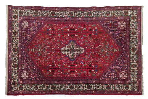 Abadeh rug having a central medallion amongst tight-knit foliage on a red ground within multi