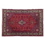 Abadeh rug having a central medallion amongst tight-knit foliage on a red ground within multi