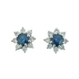 Pair of sapphire and diamond cluster earstuds, the 4.5mm diameter sapphire enclosed by eight