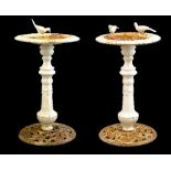 Pair of cast iron pedestal bird baths, each circular top having figural decoration of birds,