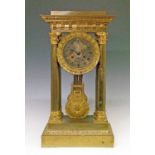 19th Century French brass and ormolu portico clock, the silvered dial with engraved decoration and