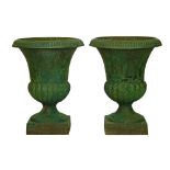 Pair of cast iron garden urns, each having reeded decoration and standing on a square foot, 60cm