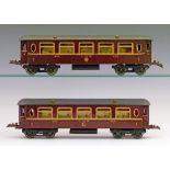 Model Railway - Hornby 0 Gauge - Two No.2 saloon coaches, L.M.S. red, boxed Condition: Most window