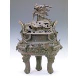 Large 19th Century Chinese bronze tripod censer, the pierced cover decorated with a dragon,
