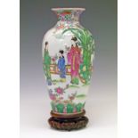 Chinese Famille Rose vase having continuous decoration depicting figures in a garden, 36.5cm high