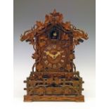 Late 19th Century Black Forest walnut and beech cased architectural style cuckoo mantel clock having