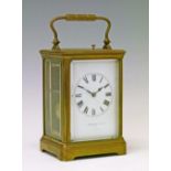 Early 20th Century French brass cased carriage clock having a repeat movement, the white enamel dial