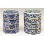 Two Chinese cylindrical four section stacking boxes, each having blue and white painted