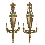 Pair of carved giltwood girandole, each having central mirrored panels within an urn and bell husk
