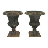 Pair of cast iron garden urns, each having fluted decoration and standing on a square foot, 50cm