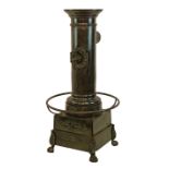 Vintage Dutch Kolom Carhel peat burning stove, having a cylindrical upper section with circular top,