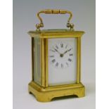 Small early 20th Century French brass cased carriage clock, the white enamel dial with Roman