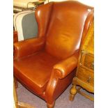 A LEATHER WING BACKED GENTLEMANS CHAIR EST [£ 30- £ 60]