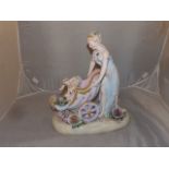 PORCELAIN FIGURE OF FEMALE WITH TWO KISSING CHERUBS IN PRAM/CHARIOT POSSIBLY GERMAN EST[£80-£120]