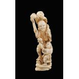 An ivory sculpture Oriental manufacture, 19th century h. 12,5 cm. modelled as an old man with two