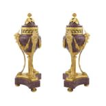 A pair of French porphyry cassolettes 19th century h. 36 cm. rich gilt-bronze applications, modelled
