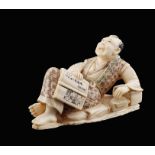 A small ivory figure Oriental manufacture, 19th century 5x8x4 cm. modelled as a lying man, on the