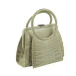 A vintage green crocodile handbag