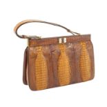 A vintage brown crocodile handbag