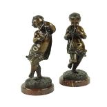 A pair of French patinated bronze putti