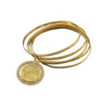 An 18k gold bracelet with a George V coin pendant