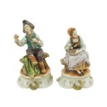 A pair of polychromatic porcelain sculptures Capodimonte, 20th century h. 18,5 - 17,5 cm.