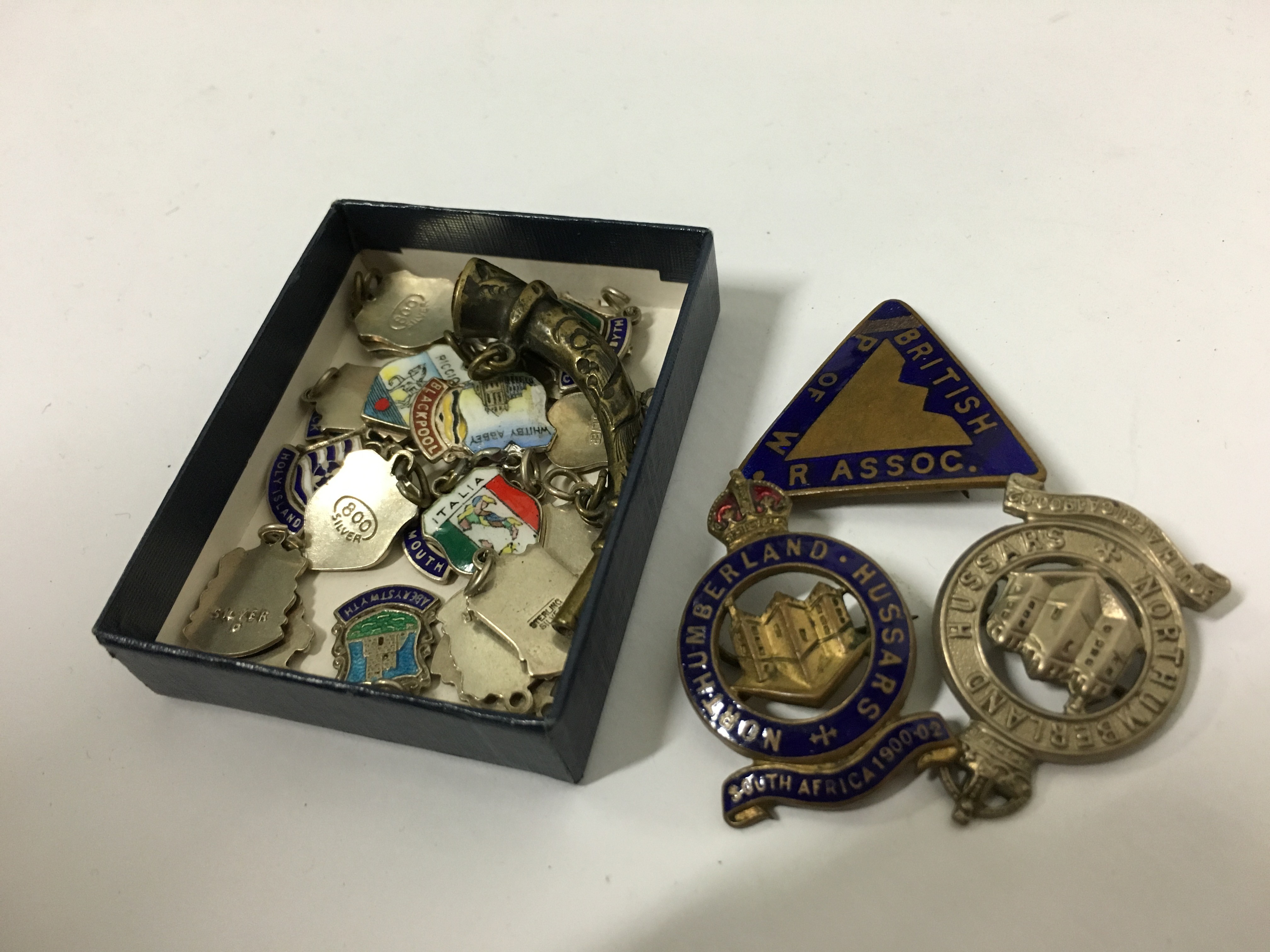 A small quantity of various silver backed enamel Holiday Resort souvenir charms together with four