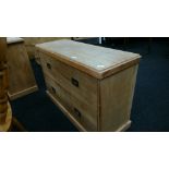A low narrow stripped pine two drawer chest with Military style handles to drawer fronts.