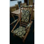 A large pitch pine American rocker with upholstered seat, back rest and arms.