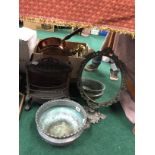 A cast iron stove together with a plant pot and brass framed mirror.