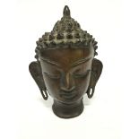 A small Eastern bronze Buddha head.