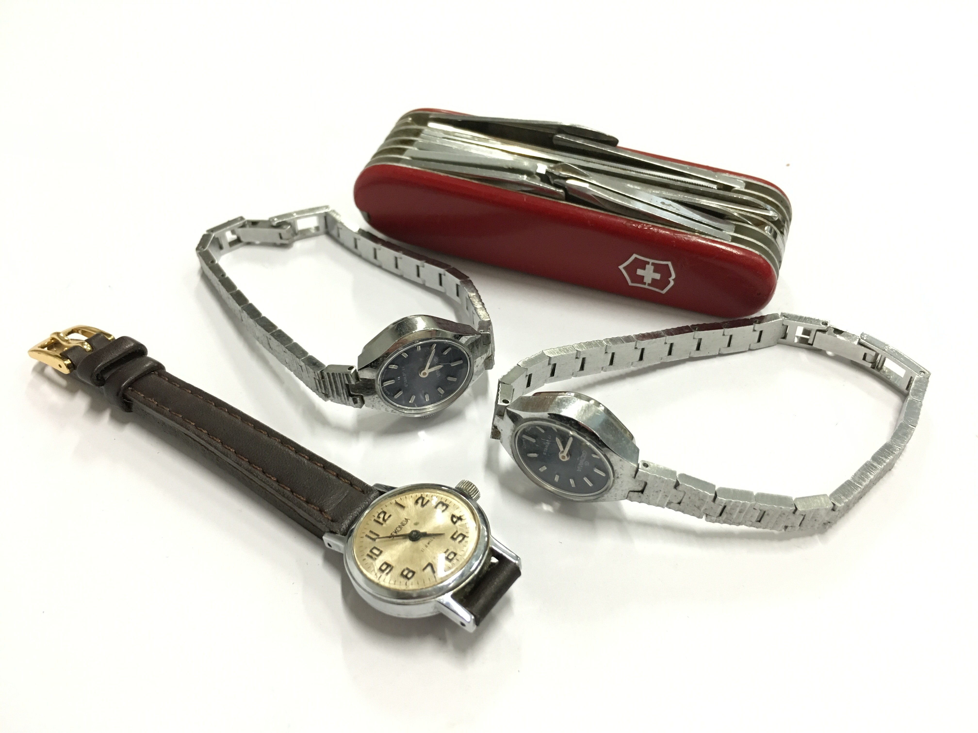 Three various wristwatches together with a Swiss pen knife.