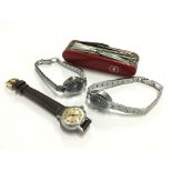 Three various wristwatches together with a Swiss pen knife.