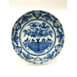 An 18th century blue and white 18th century Delft tin glazed blue and white charger decorated with