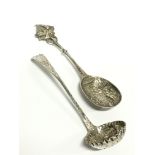 A Victorian silver sifting spoon with repousse grape and fruit decoration to bowl: Glasgow 1891