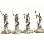 A set of four silver figural Menu holders, modelled as Nude Male figures and birds.