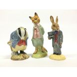 A Beswick china Beatrix Potter figure: Tommy Brock together with a Royal Doulton Bunnykins Groom