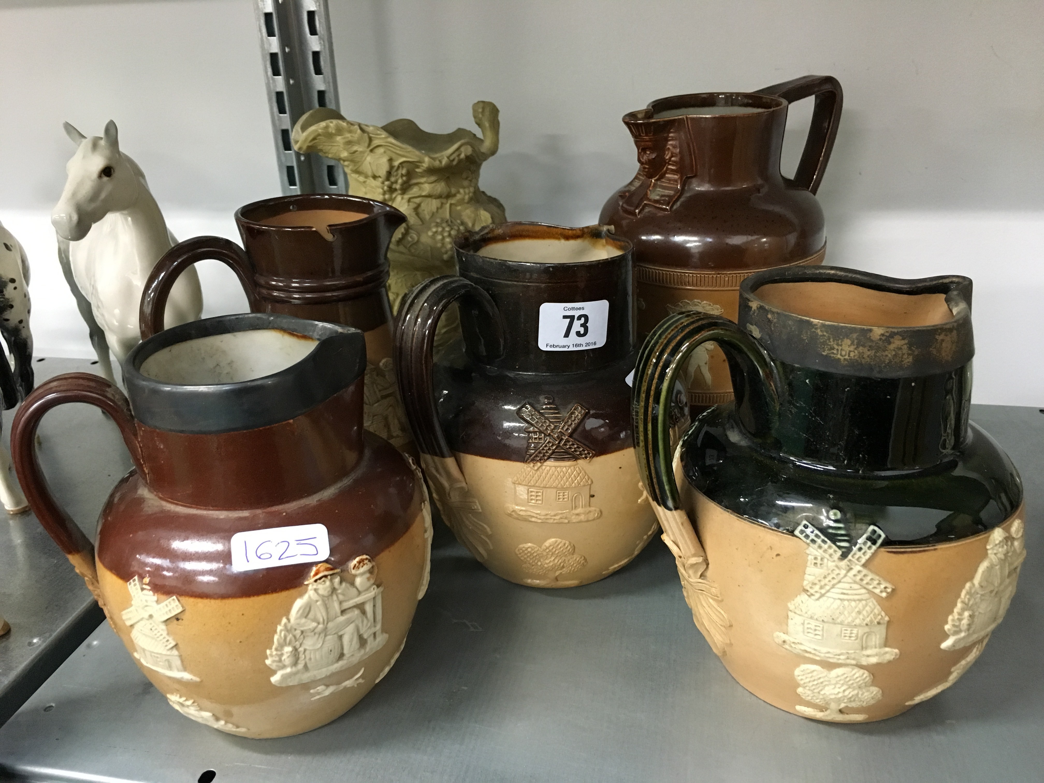 Five various 19th century Doulton stoneware jugs including two with silver rims together with a