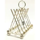 A silver plated six division toast rack modelled as Crossed Golf Clubs.