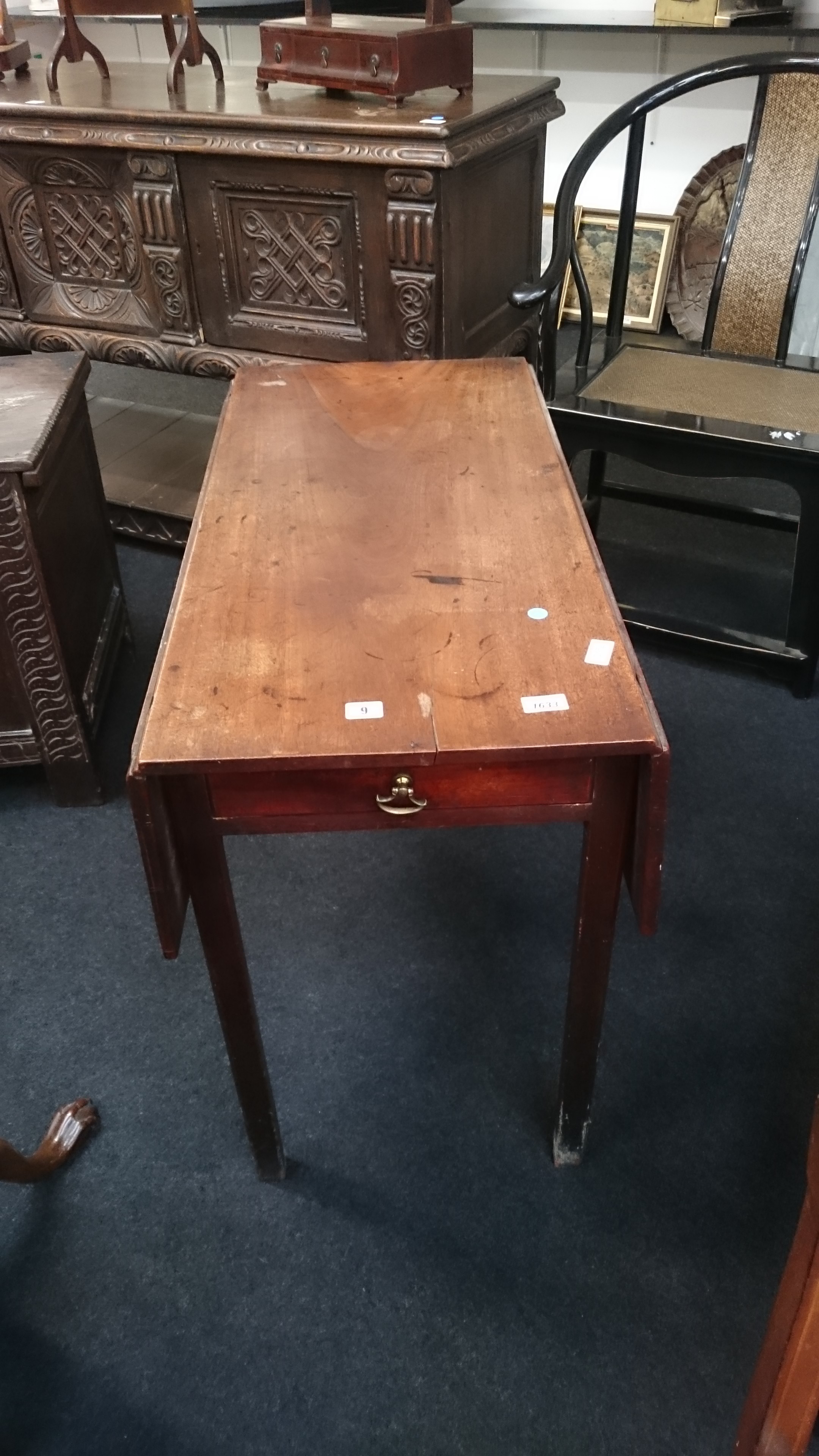 A mahogany Pembroke table with drawer to end resting on square supports.