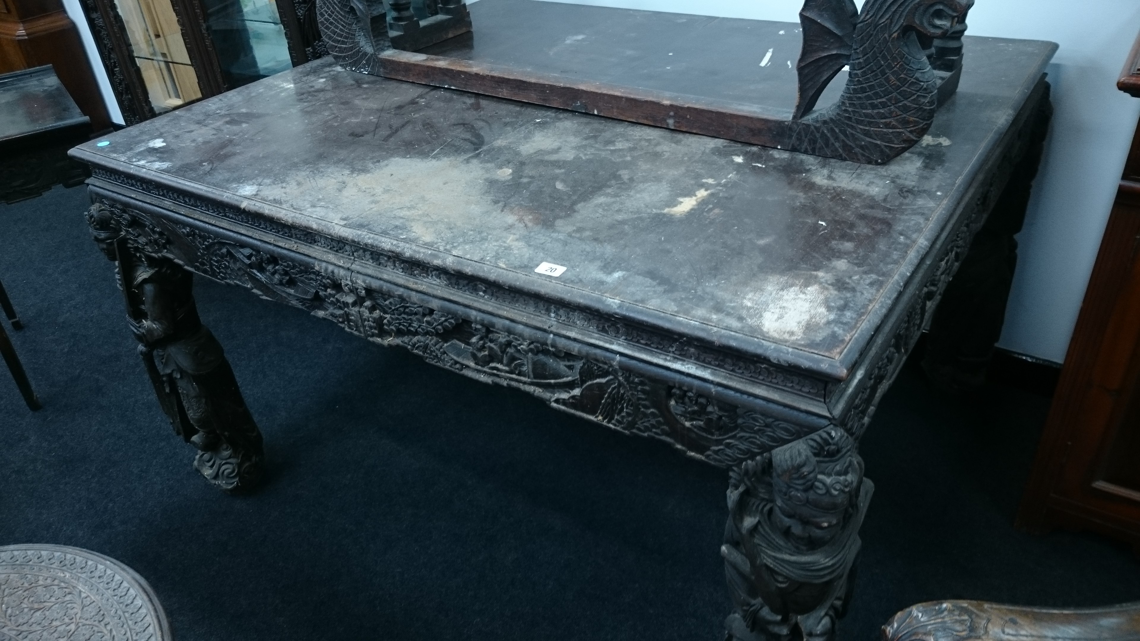 A large Chinese design hardwood square dining table with heavily carved frieze and carved legs
