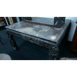 A large Chinese design hardwood square dining table with heavily carved frieze and carved legs